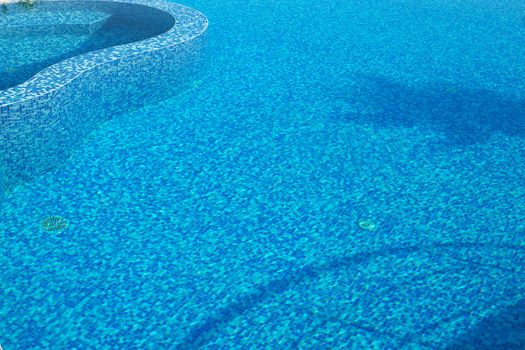 Blue water in a pool with tiles