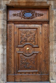 Old wooden gate with beautiful carvings in Aix en Provence, France