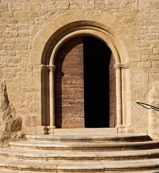 The gate of the ancient cathedral in the village Ansouis, France