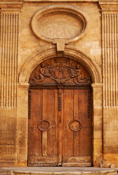 Old wooden door with ornaments in Aix en Provence, France