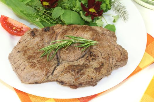 fresh Sirloin steak with wild herb salad on a light background