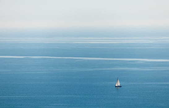 Blue sea water with a lonely boat