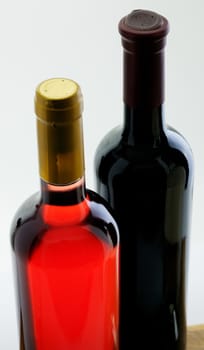 Two sealed bottles of red and white wine