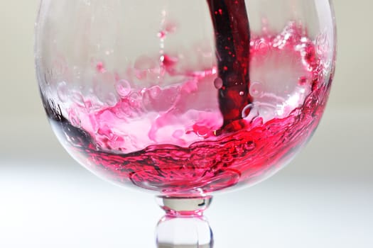 Splash of red wine in a glass