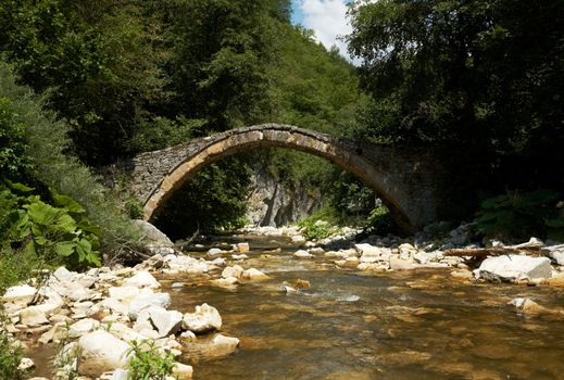 Old stone bridge and mountain stream near the cave of Yagodina, Bulgaria