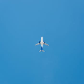 Plane in the blue sky flying