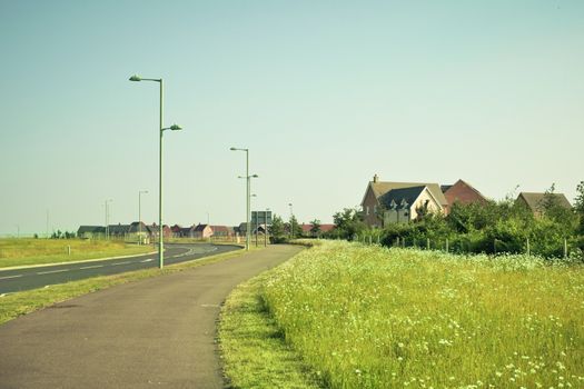 Cycle path adjacent to a modern housing estate in rural England