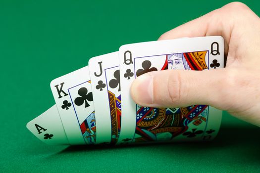 cards in a player's hand on the green table