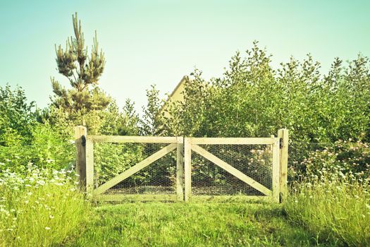 A wooden gate in a rural setting