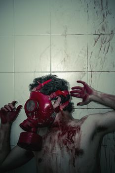 Crime scene, man with blood stains, nude with gas mask
