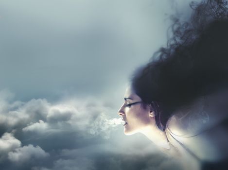 Nature concept, clouds and wind. Beautiful brunette, Healthy Long Hair and Holiday Makeup.