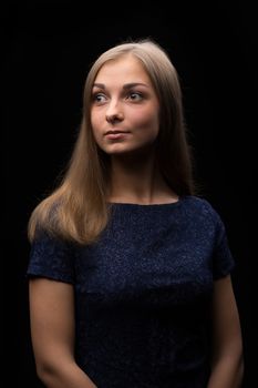 Portrait of a beautiful girl on a black background. Studio photography