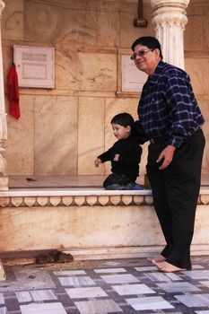 Man with a small boy watching rats at Karni Mata Temple, Deshnok, Rajasthan, India