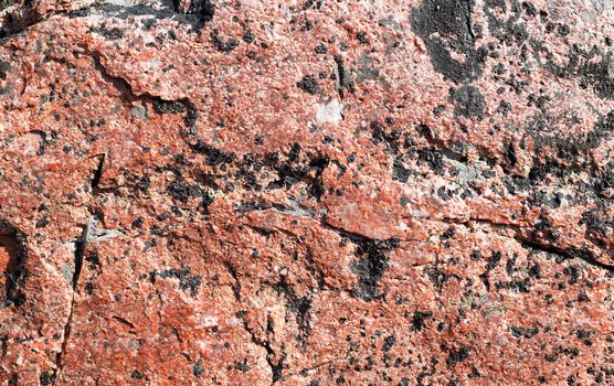 background of red granite stone in daylight