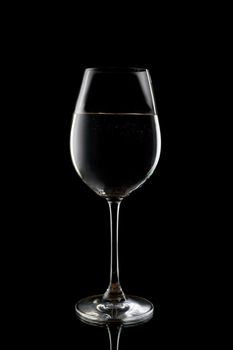 Silhouette of a wine glass with liquid. Isolate on black.