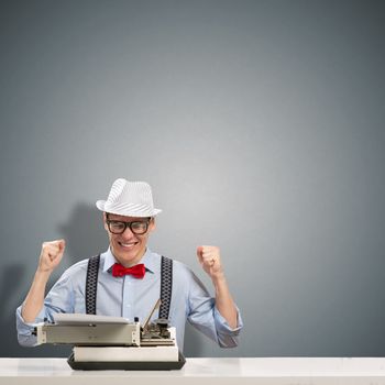 image of a young journalist, sitting at the table for a typewriter