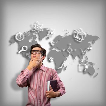 young man scientist in glasses thinking. next to it various painted symbols