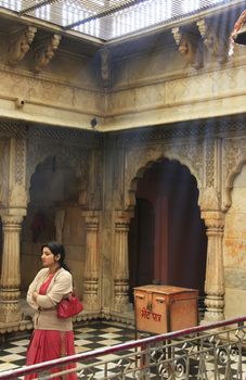 Young woman standing inside Karni Mata Temple, Deshnok, Rajasthan, India