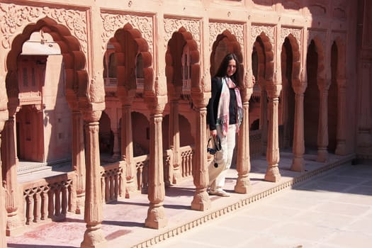 Young woman standing on courtyard terrace, Junagarh fort, Bikaner, Rajasthan, India