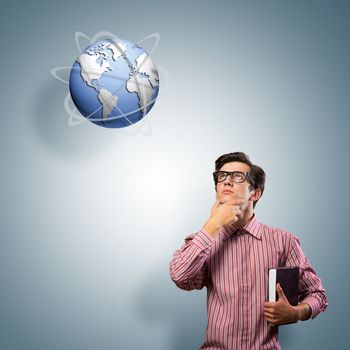 young man with a book thinks. it over symbol planet Earth