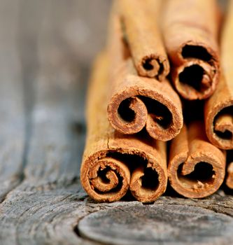 Bunch of cinnamon sticks on old wood