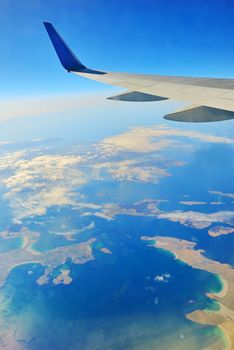 Wing of an airplane over ocean