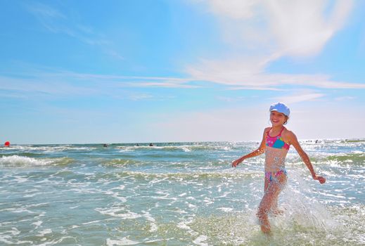 Girl running on water at sea beach