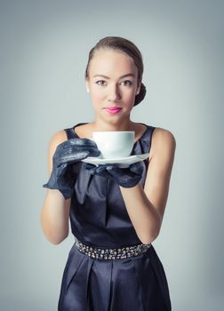 Fashion portrait of beautiful young girl with a coffee cup in classic vintage style