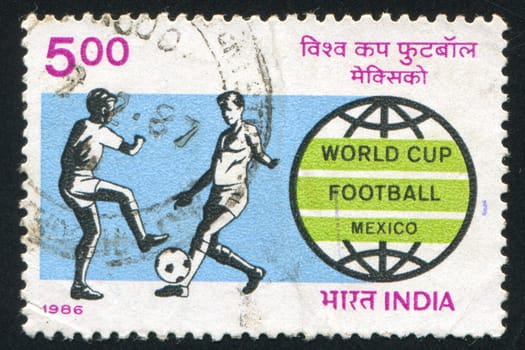 INDIA - CIRCA 1986: stamp printed by India, shows Soccer players and World Cup emblem, circa 1986