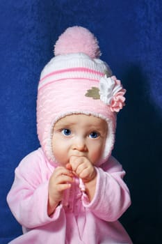 Cute little girl with blue eyes wearing pink hat