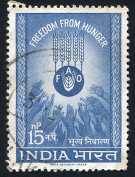 INDIA - CIRCA 1953: stamp printed by India, shows ears of rye and hands, circa 1953