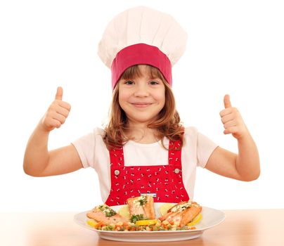 happy little girl cook with thumb up and salmon seafood