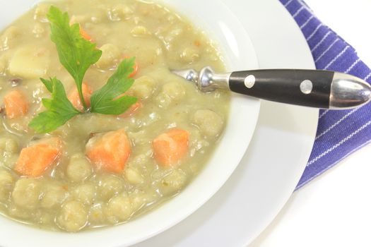 pea stew with carrots and leeks on a light background