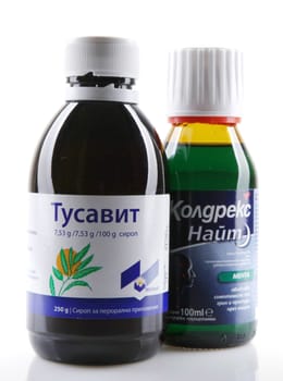 AYTOS, BULGARIA - JANUARY 28, 2014: Liquid medicine in glass bottle - Tusavit, Coldrex Nite.