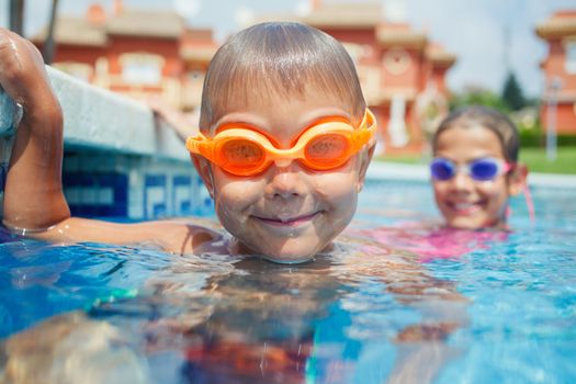 Activities on the pool. Cute boy in swimming pool