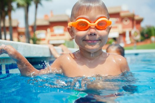 Activities on the pool. Cute boy in swimming pool