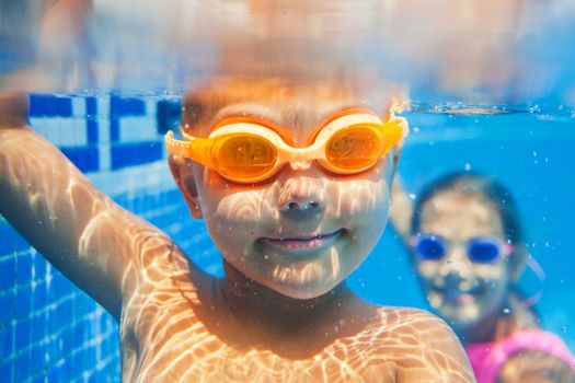 Close-up underwater portrait of the cute smiling boy