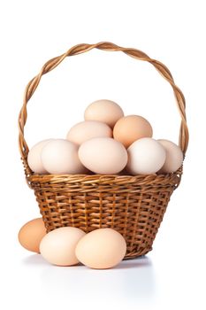 Chicken eggs in basket on white background