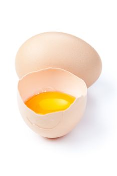 Broken egg with yolk and egg on white background