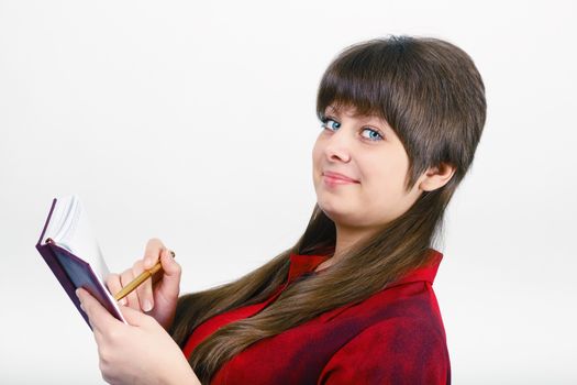 young attractive woman with a notepad and pen