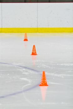 Pylons on the ice in an arena