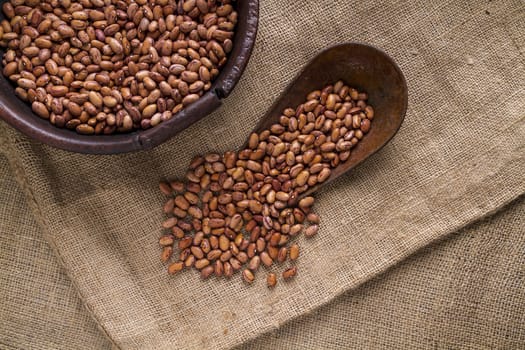 Bowl with beans, on a background of sackcloth