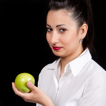 Woman holding a green apple in hand