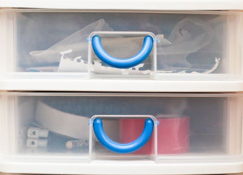 Close up of two small plastic storage drawers