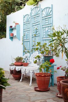 Garden of a Greek Villa with shrubs and a bench