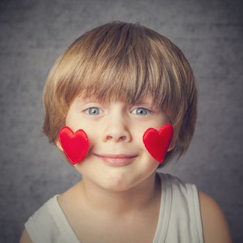 Portrait of a boy with hearts on face