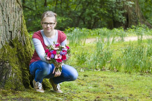 cute young girl with flowers - gift for the mother