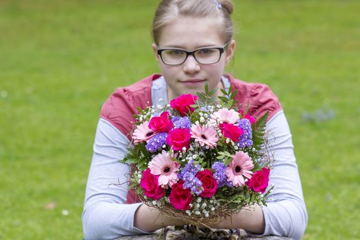cute young girl with flowers - gift for the mother