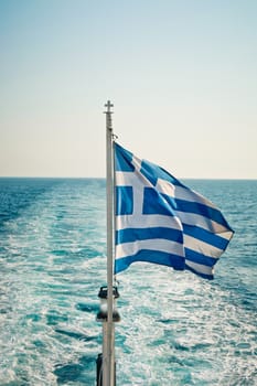 Greek flag flying on a ferry sailing