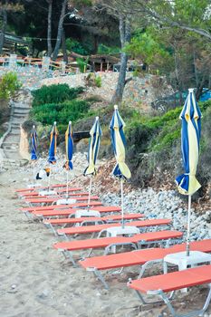 Row of sunloungers on a beach in Greece